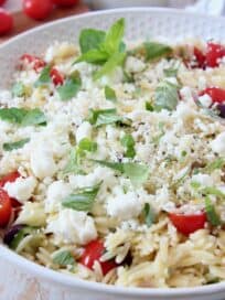 orzo salad with tomatoes, mint and feta in white bowl