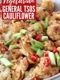general tso's cauliflower in bowl with diced scallions and rice
