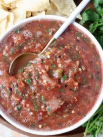 fresh tomato salsa in bowl with white spoon