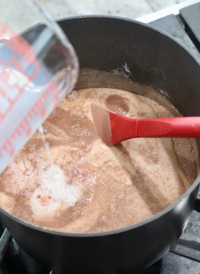 milk pouring into saucepan to make chocolate pie filling