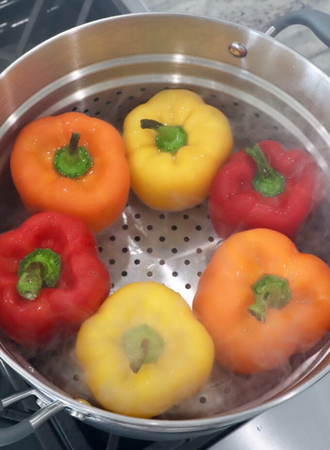 bell peppers in steamer basket on stove