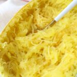 cooked spaghetti squash on plate with fork