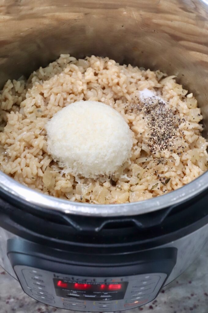 cooked risotto in Instant Pot with parmesan cheese and seasonings