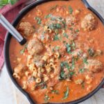 meatball soup in skillet with serving spoon
