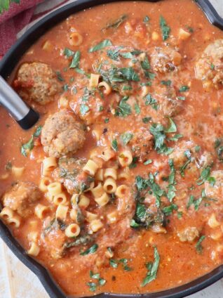 meatball soup in skillet with serving spoon