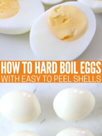 hard boiled eggs cut in half on plate and whole peeled hard boiled eggs on cutting board