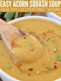 acorn squash soup in bowl with wooden spoon