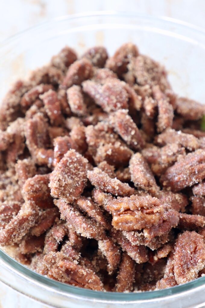 pecans coated in sugar in glass bowl