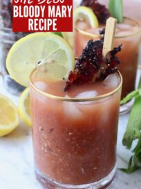 bloody mary in glasses with cooked peppered bacon, lemon slice and celery stick