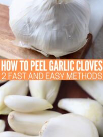 whole head of garlic and peeled garlic cloves on cutting board