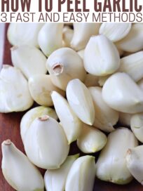 peeled cloves of garlic on brown cutting board