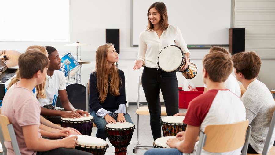 Drumming game with students.