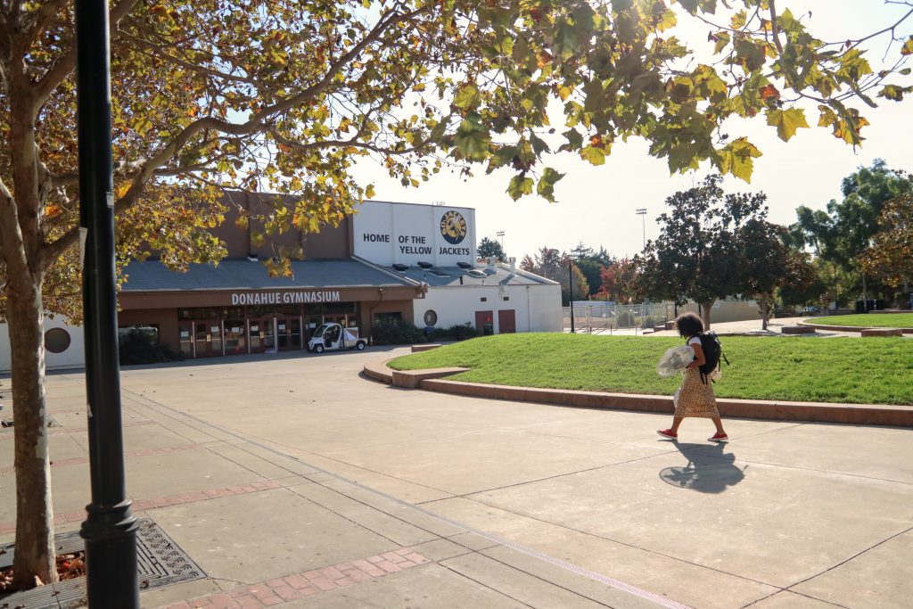Student walks across empty Berkeley High School campus, which has not been reopened yet.
