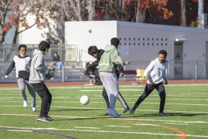 During lunch, students snack mid-soccer game on the Jacket field
