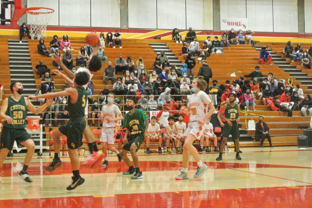 Mekhi Boyd, a junior varsity basketball player, jumps with the ball at the February 11 game.