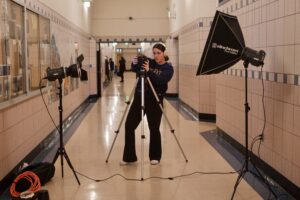 Eisen sets up filming equipment in the G-Building hallway.