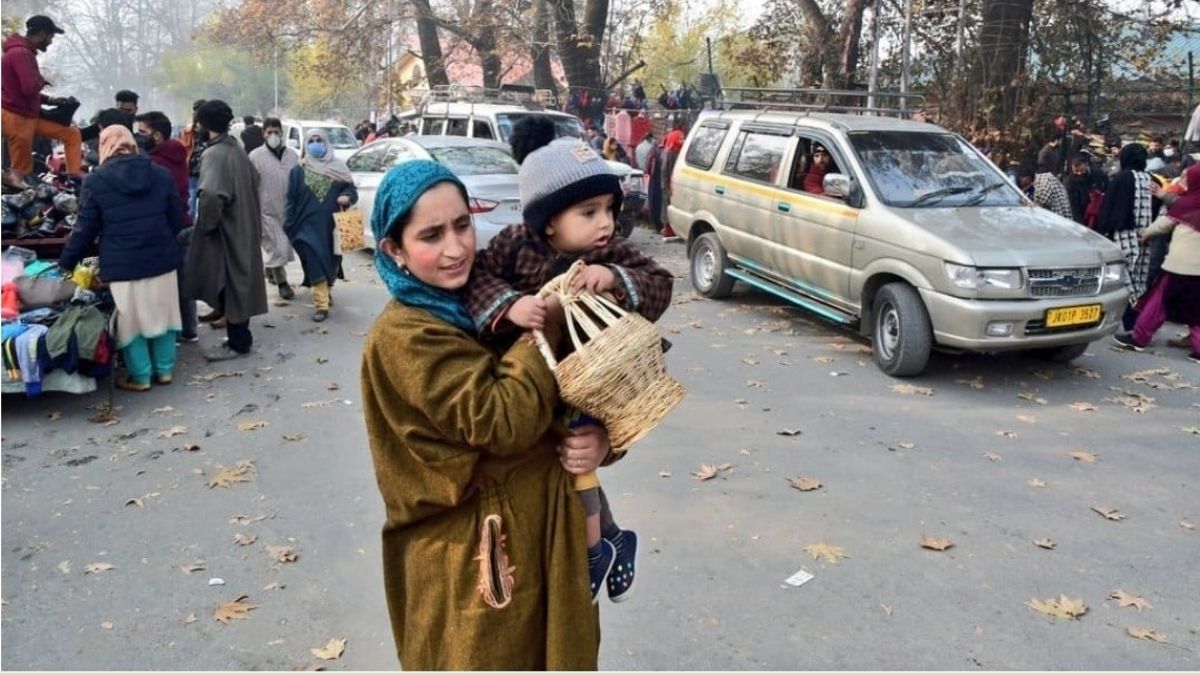 A Kashmiri woman carrying home a Kangri