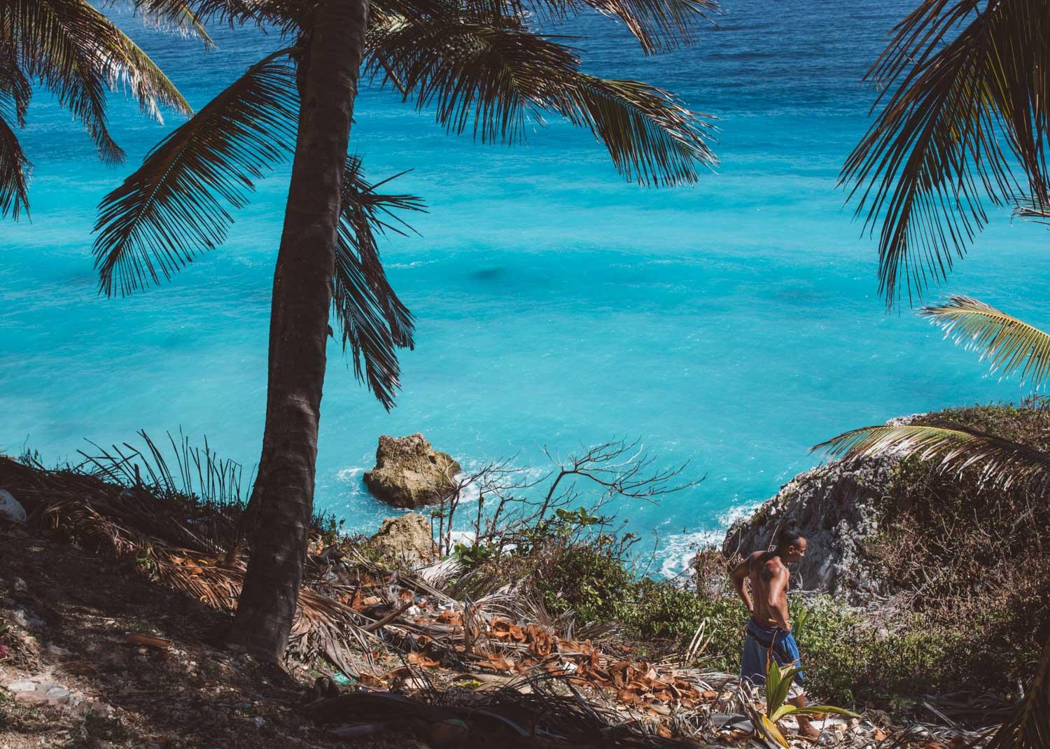 Admiring the cyan-cerulean blue color of the Barahona beaches from the side of a mountain.