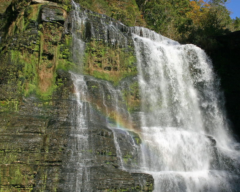 tall waterfalls w a rainbow