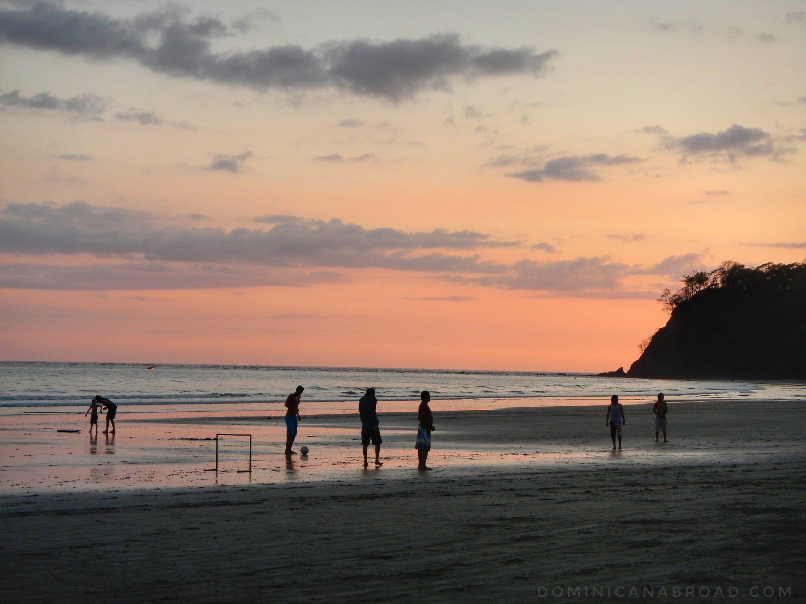 Silhouettes of people at a beach in Costa Rica at sunset.