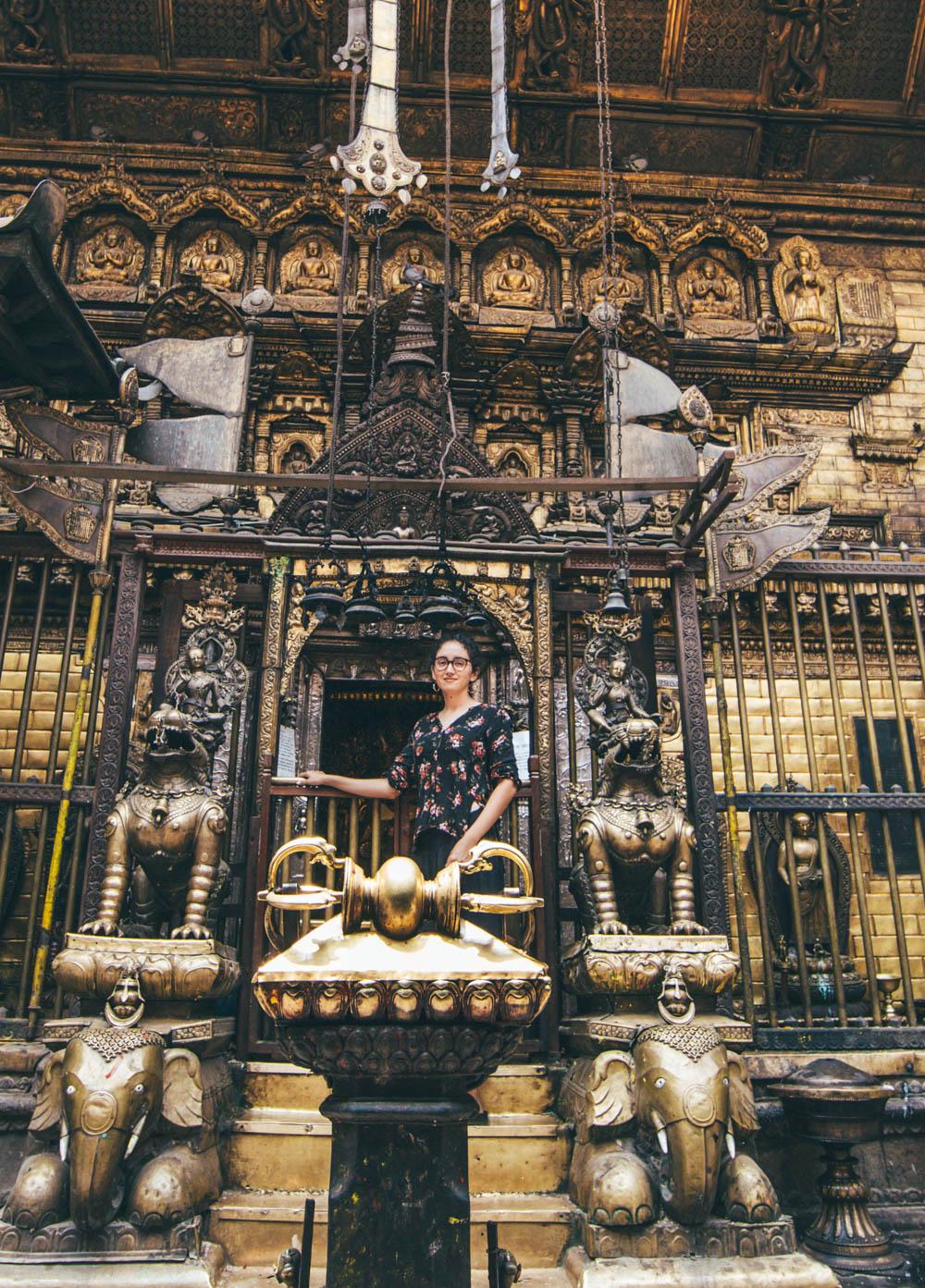 A woman at a temple in Patan Ancient City, one of the places to visit in Kathmandu.