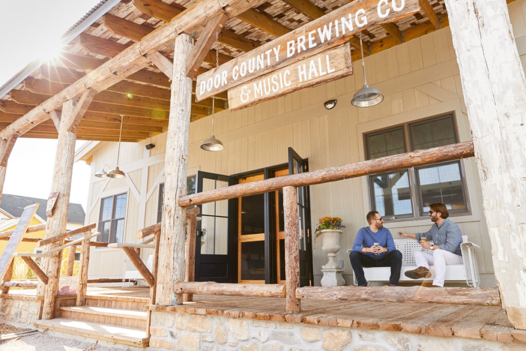 two dudes drinking beer in a door county brewery