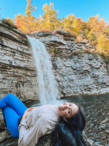 Woman lying down on a rock near Awosting Falls