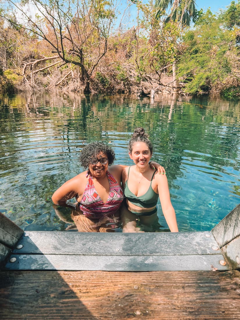 Two women in swimsuits at Indigenous Eyes Ecological Reserve, Punta Cana.