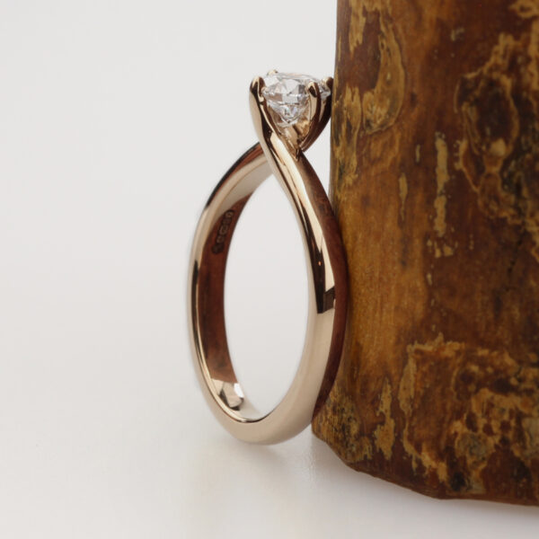 Unique 18ct rose gold twisted prong solitaire ring