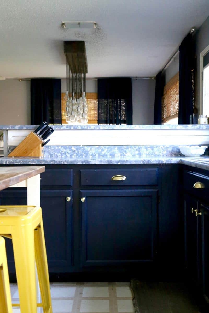 I love this gold hardware! It's amazing what a simple little update can to do totally transform a room. And can you believe those countertops are painted?!
