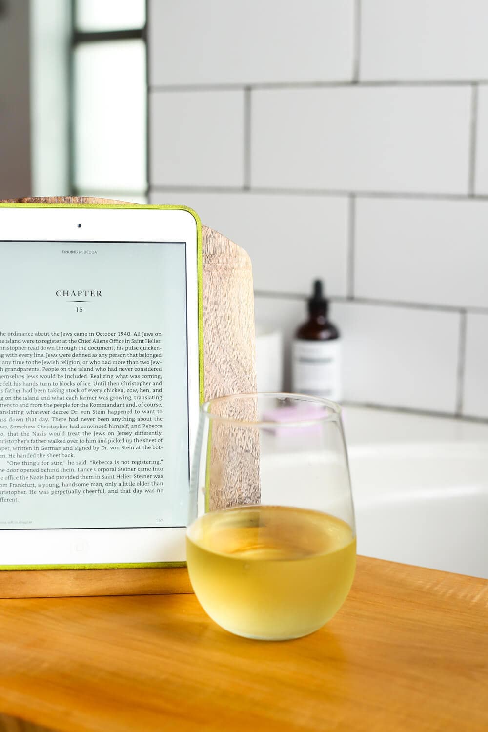 close up of a bath tub tray with an iPad and a glass of wine