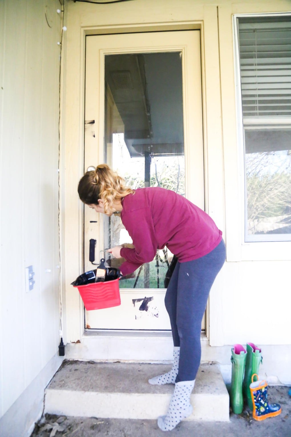 Using HANDy's Pro Pail to paint a back door