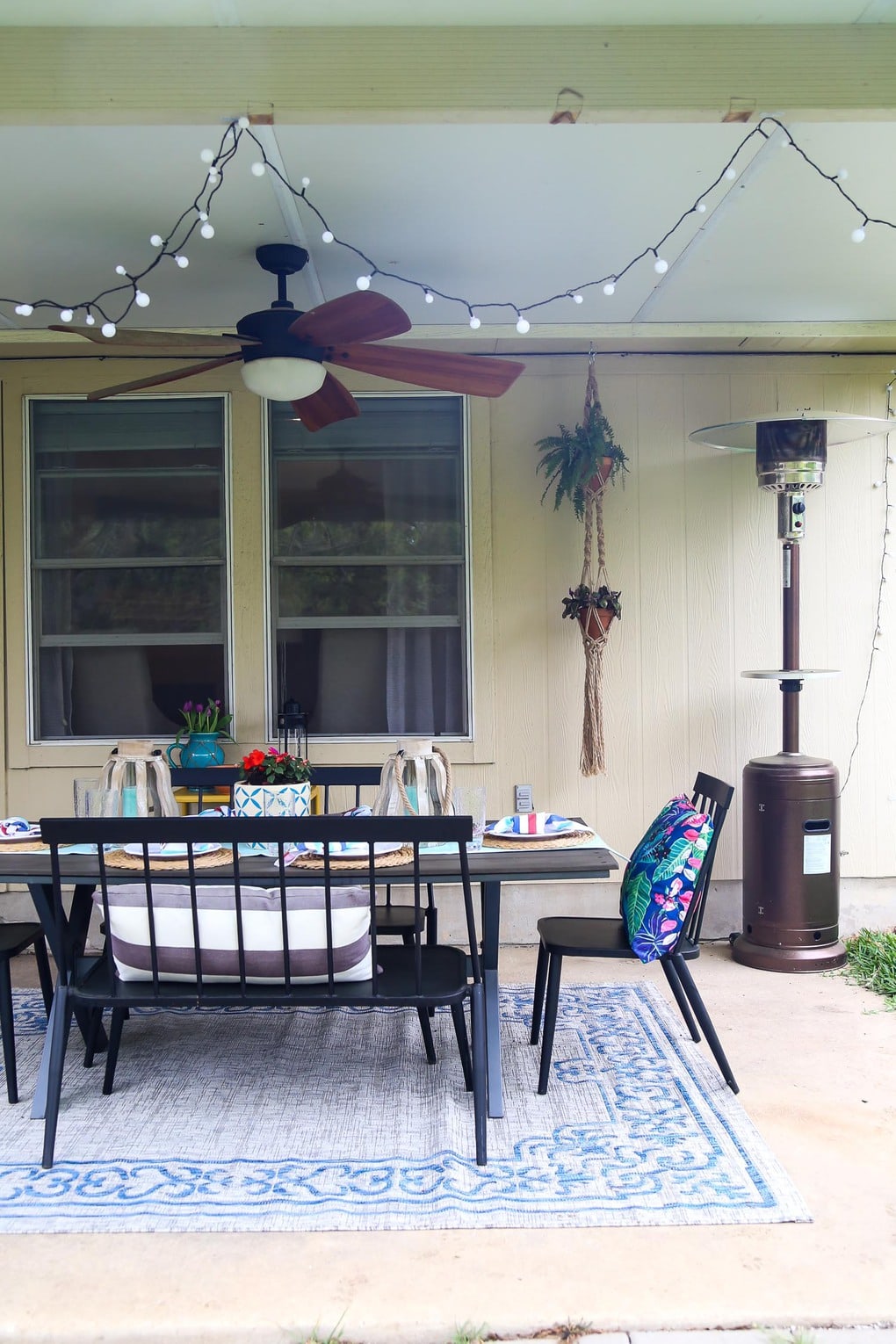 Back patio with black furniture and string lights
