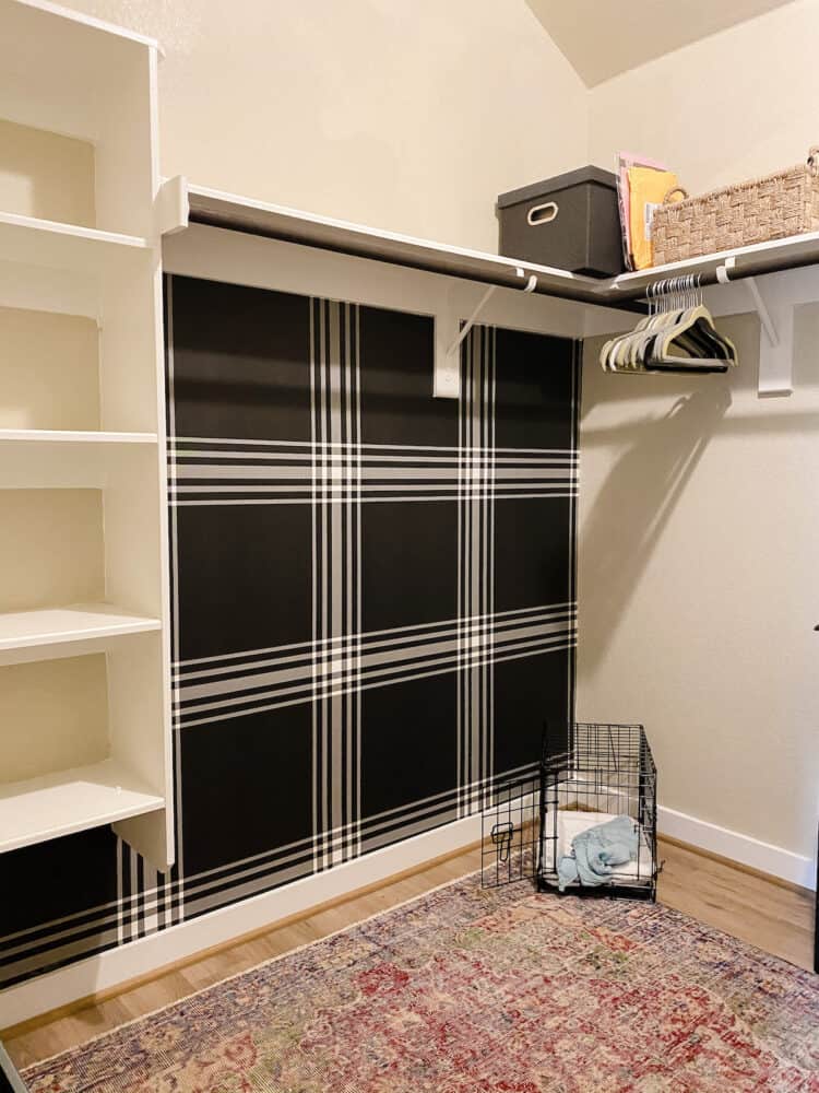 Closet with black plaid wallpaper and a vintage rug