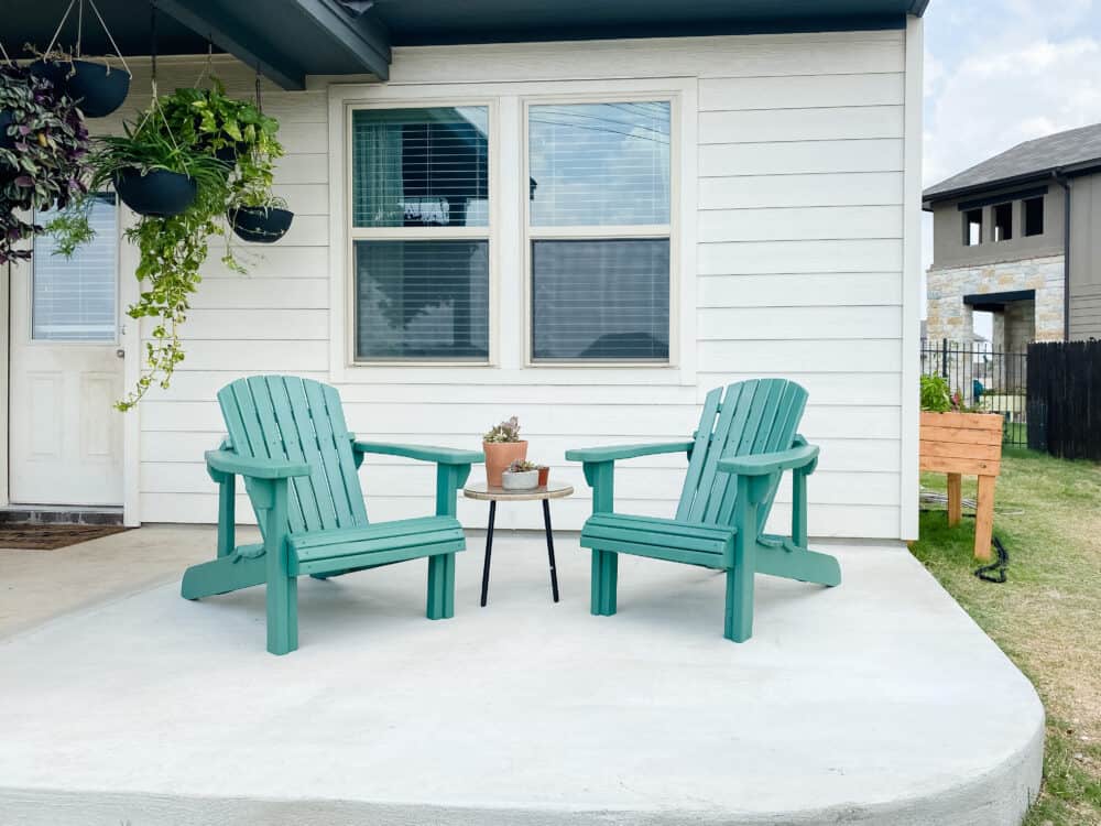 A small patio with DIY adirondack chairs 
