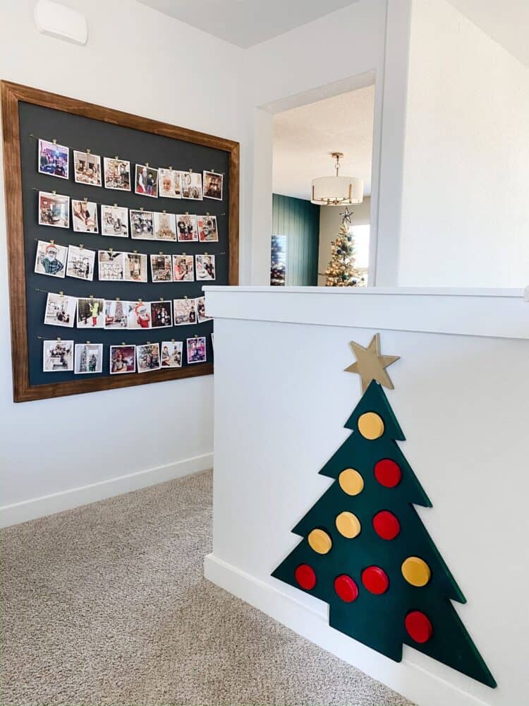 upstairs landing with photo display and interactive wooden Christmas tree