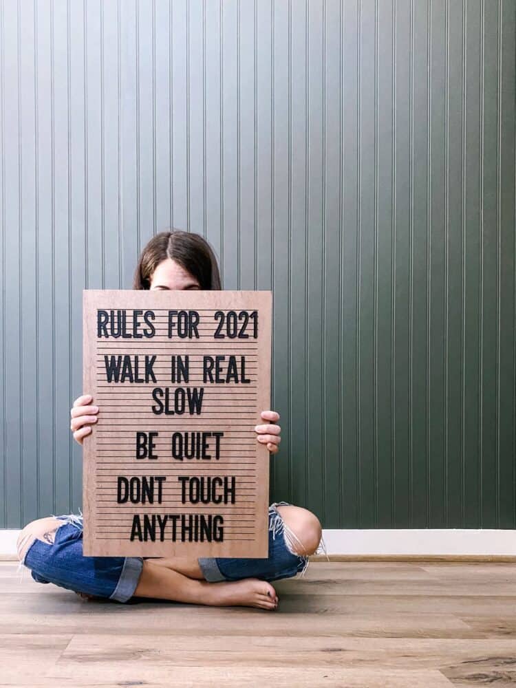 woman holding a letter board 