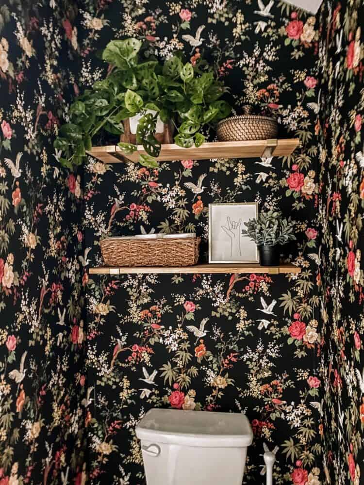 small toilet closet with shelving above the toilet 