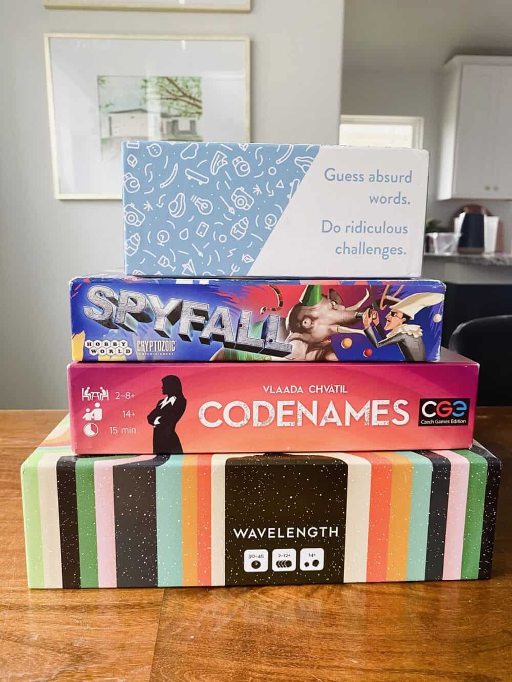 Stack of board games, includes Wavelength, Codenames, Spyfall, and Rabble