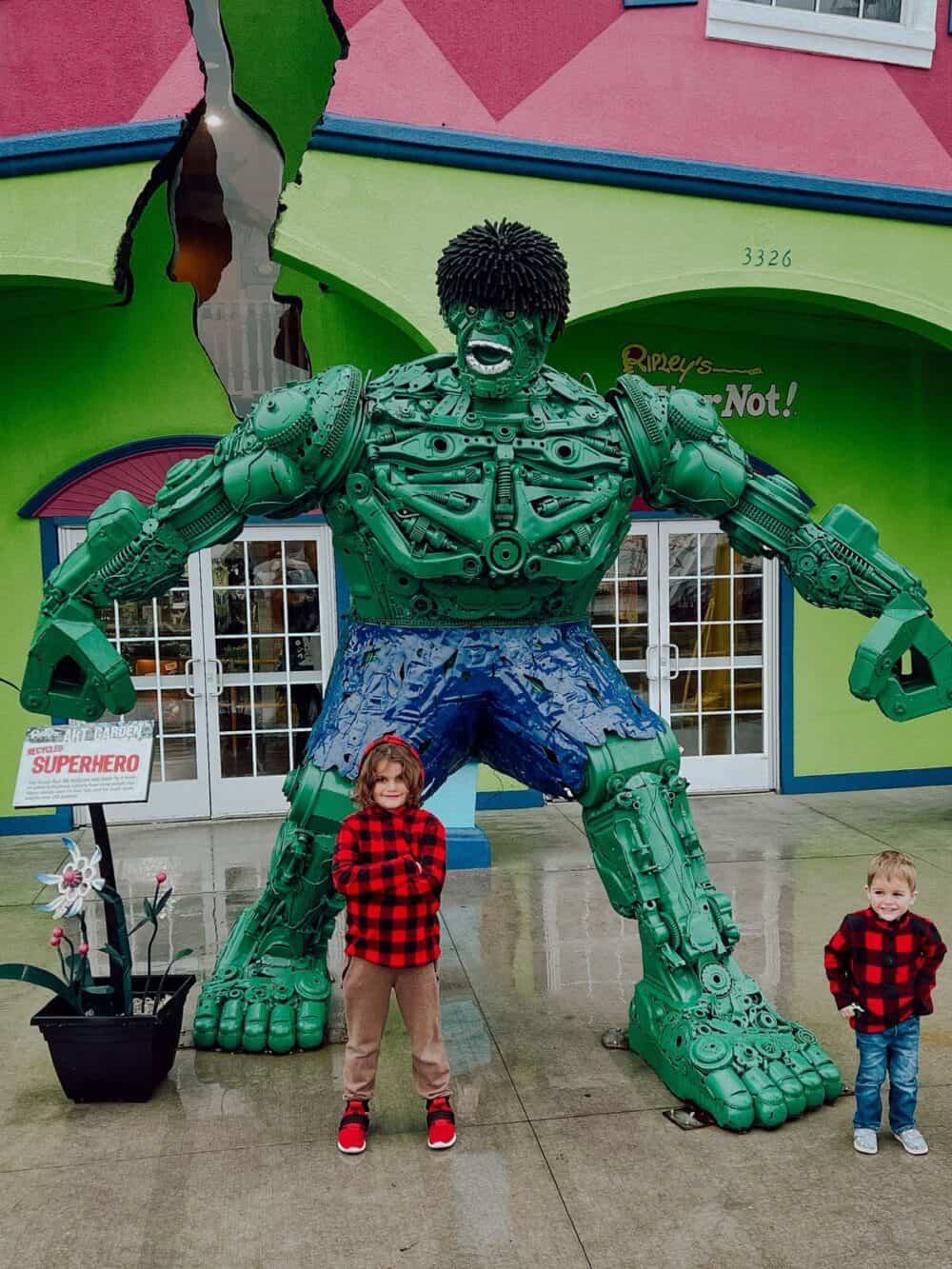 Two boys posing for a photo in front of a museum in Branson