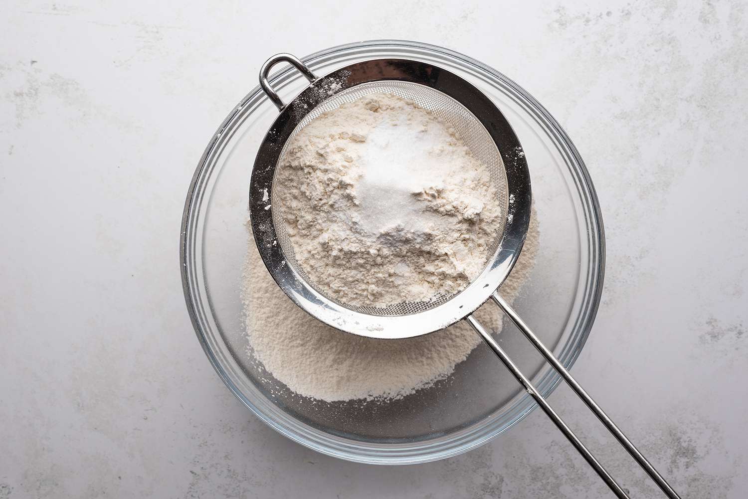 Flour, baking soda, and salt sifted into a glass bowl 