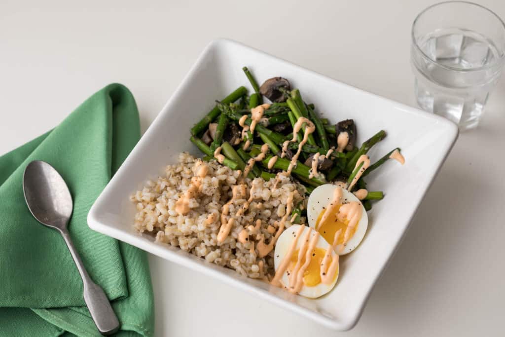 parmesan pearl barley grain bowl with asparagus and eggs