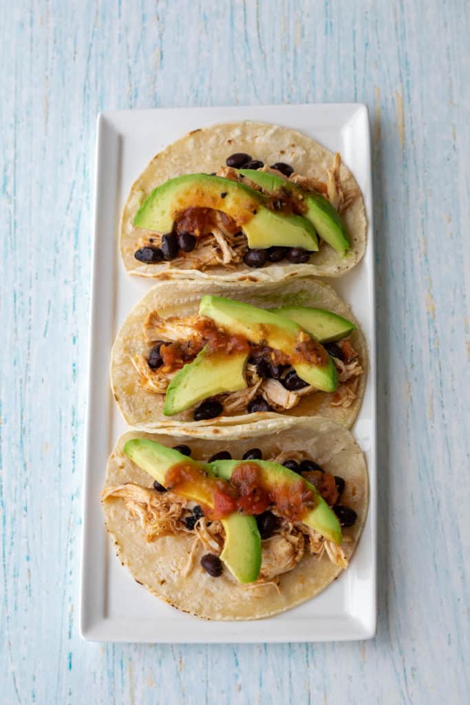 5-ingredient slow cooker chicken tacos on a rectangular white plate