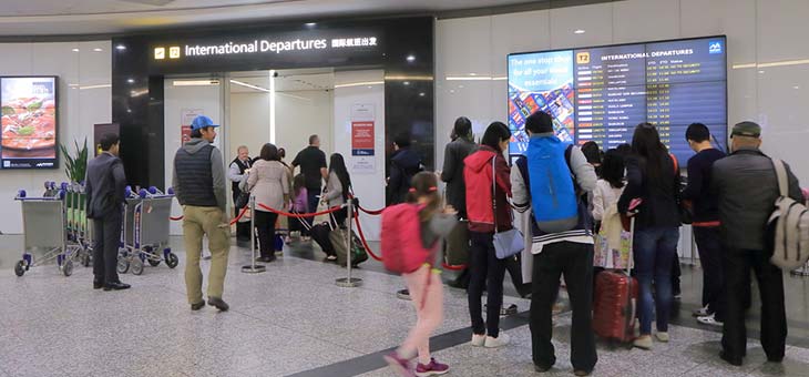 passengers at melbourne's international departures gate