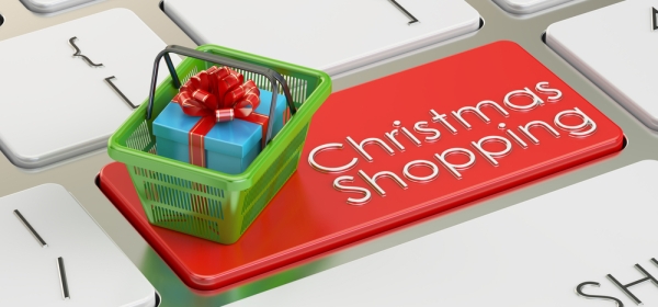 Christmas presents in shopping basket on keyboard