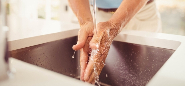 Man washing hands with soapless cleanser at sink