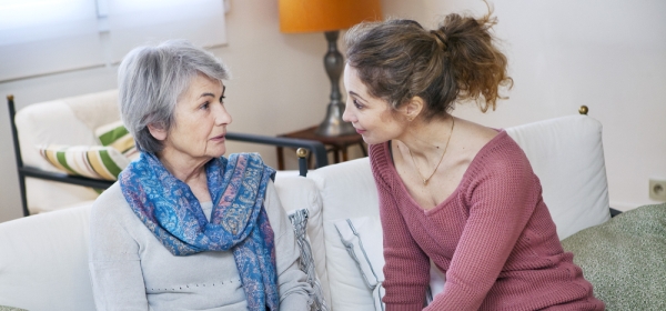 Mature daughter speaking to her elderly mother about power of attorney