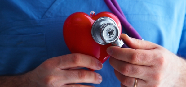 Nurse holding heart with stethescope